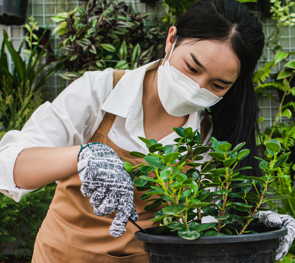 lady in the garden wearing mask and gloves